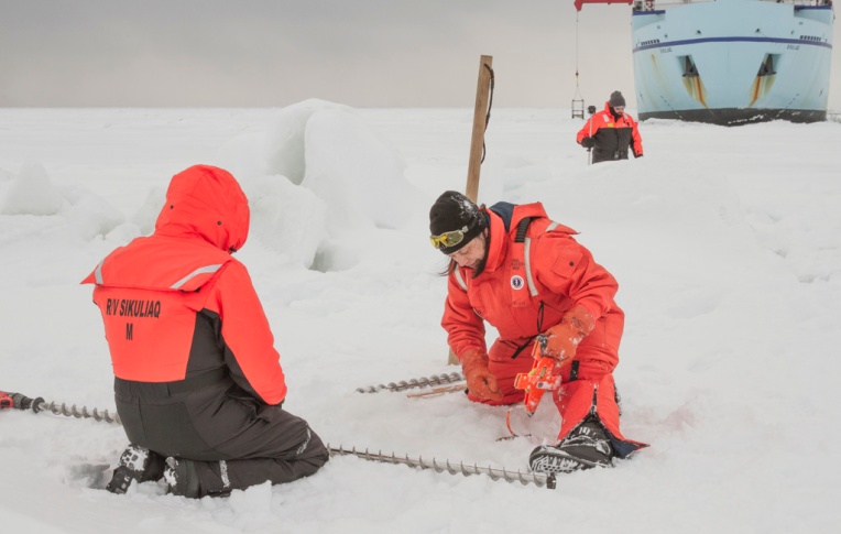 Perry Pungowiyi, Alice Orlich, and Mike Neville measure the ice for the performance test.