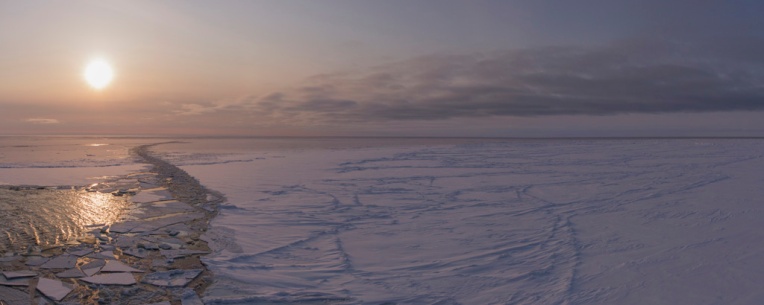 Sikuliaq, sunset, and sea ice.