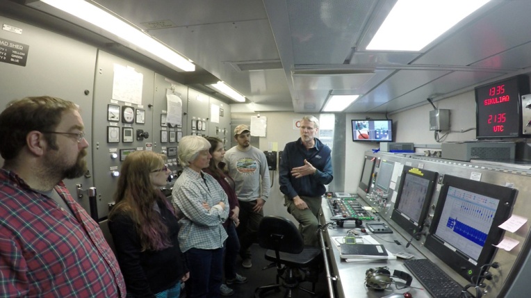 Terry gives the science team a tour of the engineering control room.